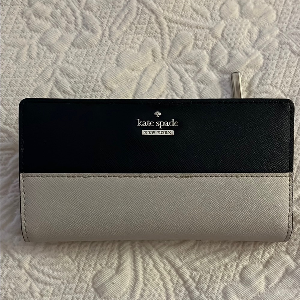 Black & off white Kate Spade wallet with inside snap in closure.
